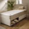 Candy-1 - Jamies Furniture Beige single bed with built-in under-bed storage, pillows and cozy throw in a bright, neutral-toned bedroom.
