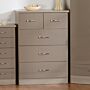 100-102-090_1 - Jamies Furniture Light brown five-drawer dresser with metal handles against a wall in a tidy room.