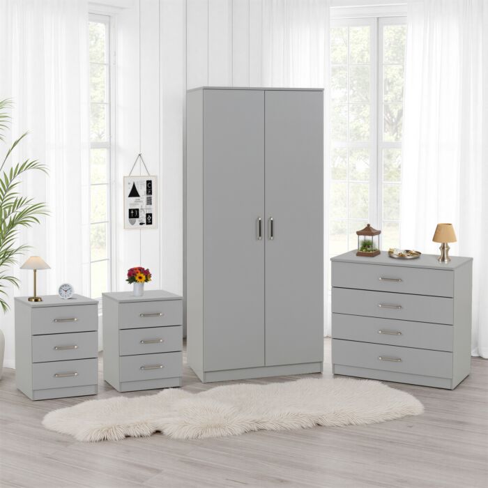 100-108-093 - Jamies Furniture Light gray bedroom furniture set with a tall wardrobe, two matching nightstands, and a five-drawer chest in a bright, airy room.