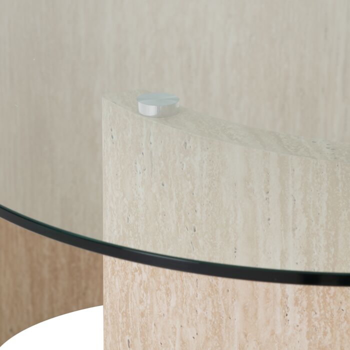 400-401-380_05 - Jamies Furniture Close-up of a glass tabletop edge resting on a beige stone pedestal, with a small white cap on top of the pedestal asset.